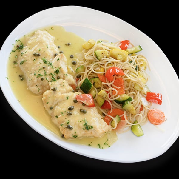 Chicken piccata with capers and lemon sauce, served with spaghetti and mixed vegetables.