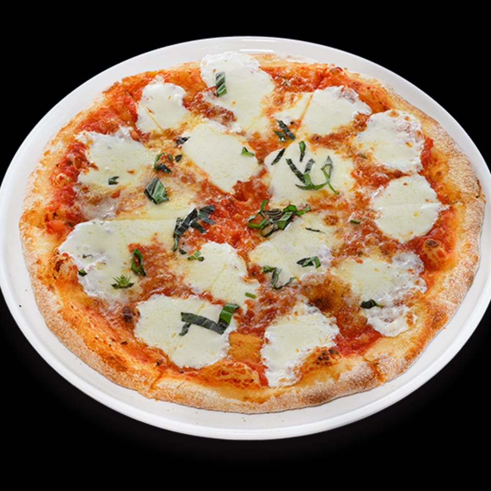 il Mulino's Italian Margherita pizza with fresh mozzarella, tomato sauce, and basil on a white plate.